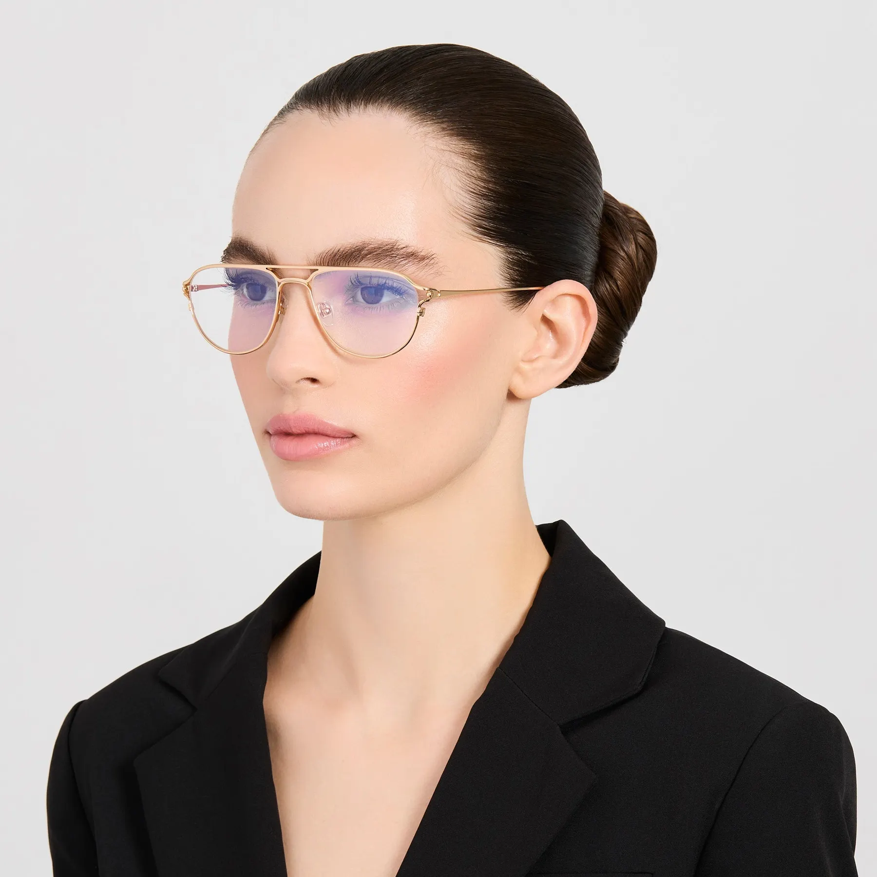 Model wearing Jacquemus Acapulco optical glasses in Light Gold