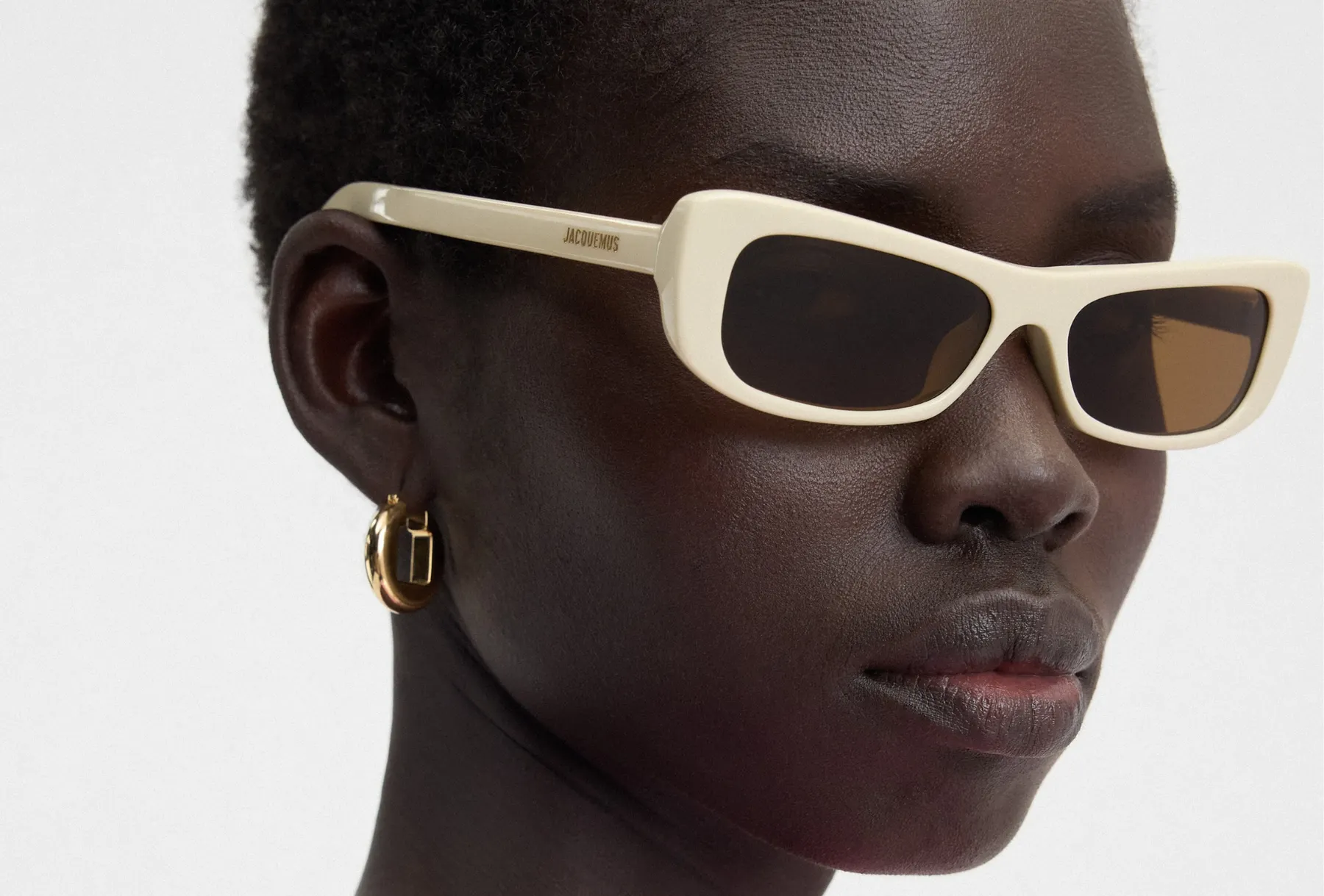 Campaign portrait wearing light-coloured Jacquemus sunglasses