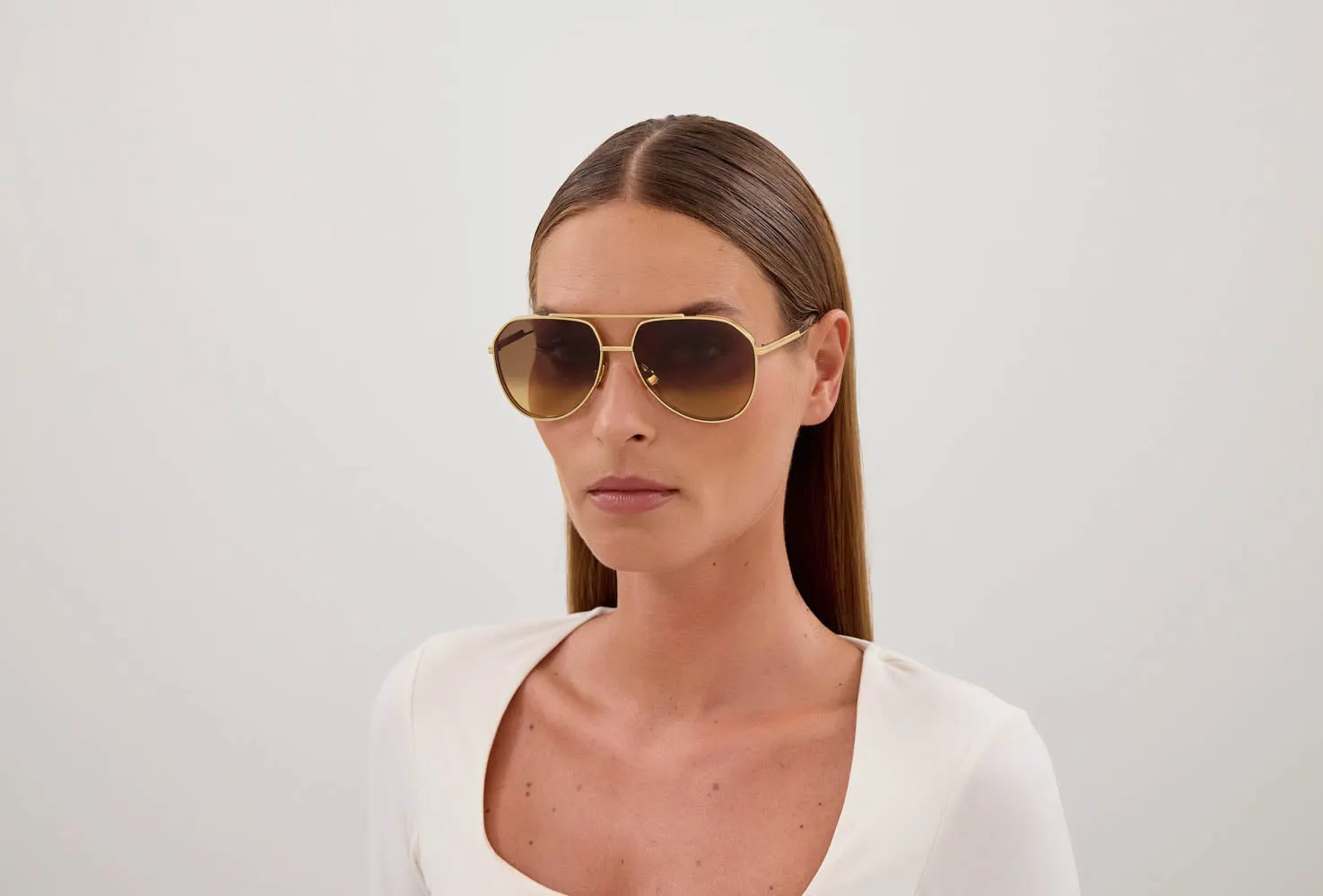 Bottega Veneta BV1465S sunglasses, colour Gold, worn on a model