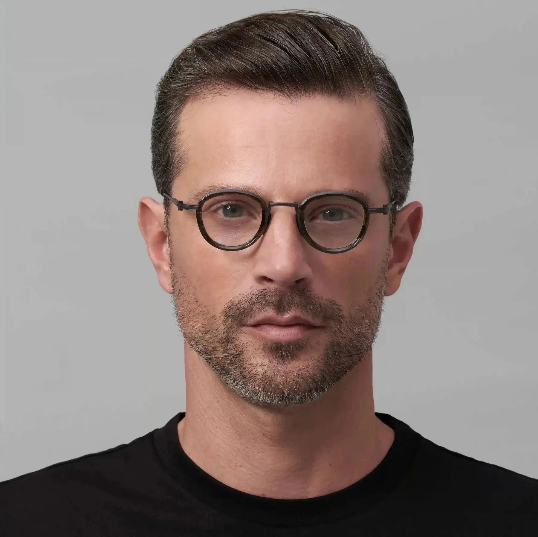 Man wearing Akoni Agile optical glasses in Black Iron/Green Tortoise Swirl, front view