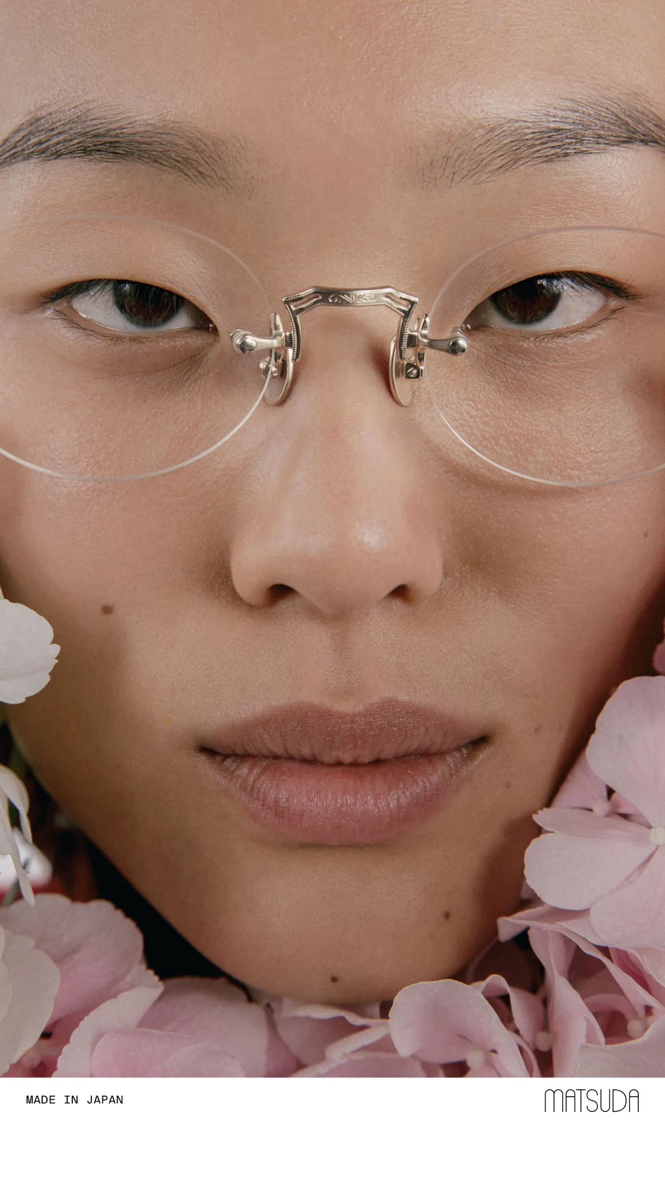 A woman wearing Matsuda M5002 optical glasses in Brushed Gold, front view
